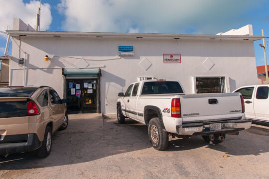 Vehicles parked outside the simple Seaview Supermarket on South Caicos