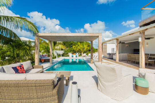 Pool and patio with seating and loungers