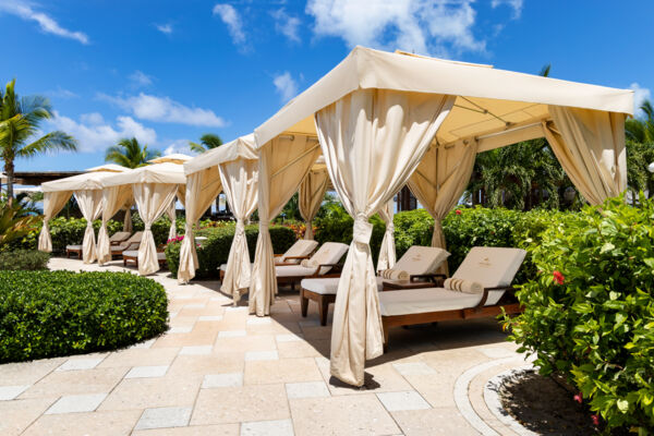Shaded pool cabanas and loungers at Seven Stars