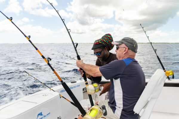 Reeling in fish on a Turks and Caicos fishing charter. 