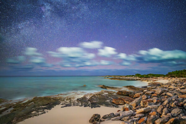 Long exposure of the Milky Way and colorful night sky on a Turks and Caicos beach.