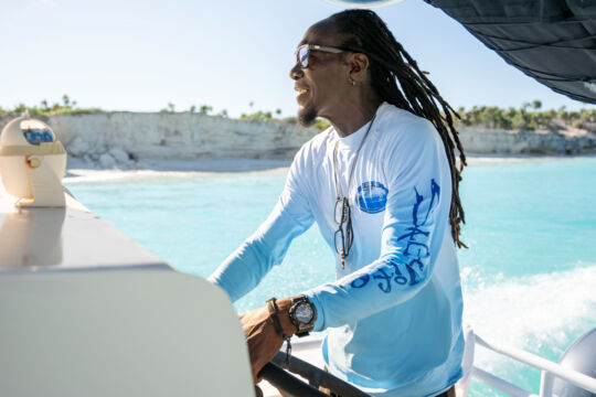 Turks and Caicos tour guide captaining a boat. 