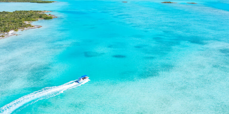 Aerial photo of a tour boat exploring the south coast of Half Moon Bay, Turks and Caicos.