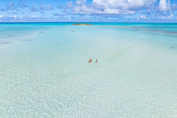 People wading in shallow waters off Bambarra Beach, Middle Caicos. 