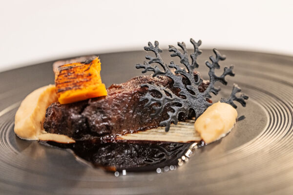 Close-up of a gastronomic wagyu short rib at a chef's table restaurant. 