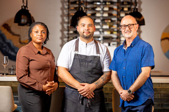 Team photo of chef, sommelier, and server.