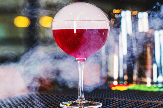 Purple cocktail with an edible bubble. 