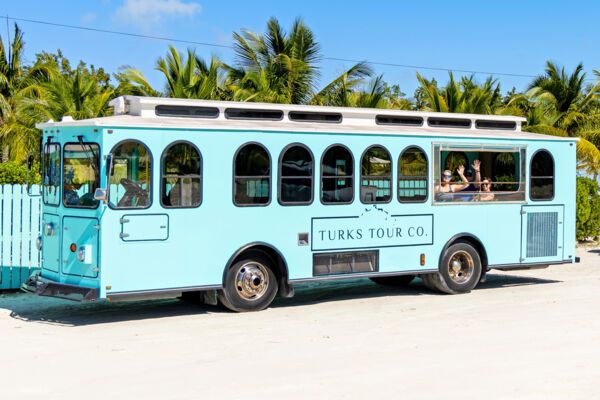 Guests waving from a trolley bus in Turks and Caicos.