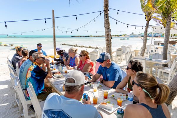 Tour group enjoying lunch beachfront in Turks and Caicos.