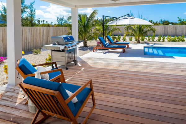 Dining table on a terrace next to a pool