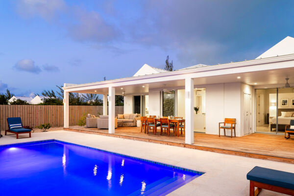 Dining table on a terrace next to a pool