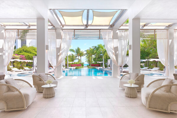 Modern lobby and pool at a Caribbean resort.