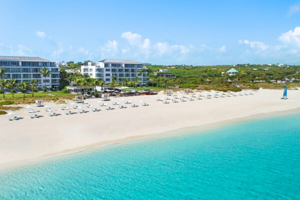 Luxury resort on a clean white-sand beach with turquoise water. 
